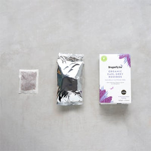Tea Packaging layout of the Dragonfly Organic Rooibos Tea range on a Grey Marble Effect Background. Box of Organic Earl Grey Rooibos Tea, with the Inner Pouch and Tea Bag on display.